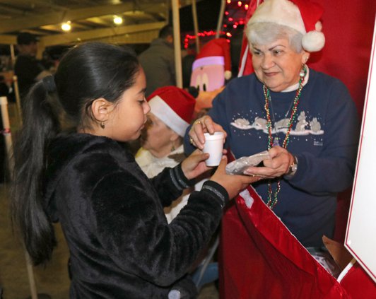 Betty Khan hands out cookies.jpg